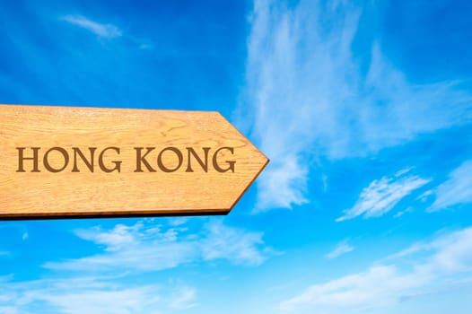 Wooden arrow sign pointing destination HONG KONG against clear blue sky with copy space available. Travel destination conceptual image