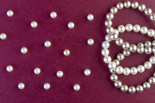 Silver and White pearls necklace on dark red background