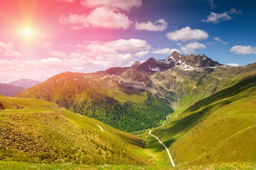 Colorful Alpine landscape scenery with sun setting down