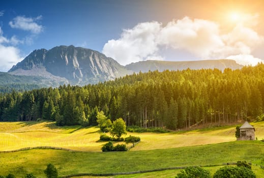 Colorful Alpine landscape scenery with sun setting down