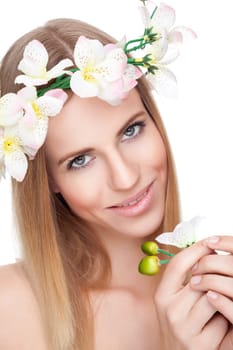 Beautiful young blonde woman with a crown of flowers