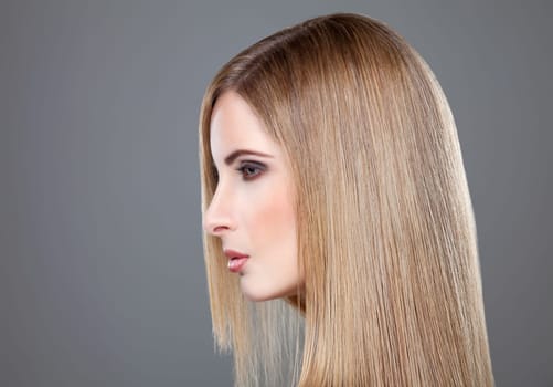 Profile of a beauty with long straight blonde hair