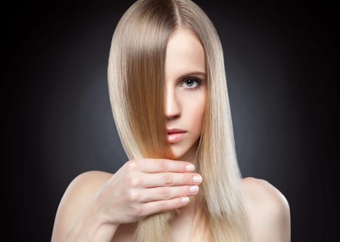 Profile of a beauty with long blonde straight hair