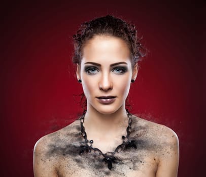 Beautiful woman's dark necklace expodes into pieces