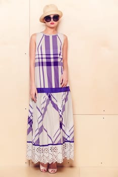 Full-length portrait of a lovely woman in romantic dress on wodden background