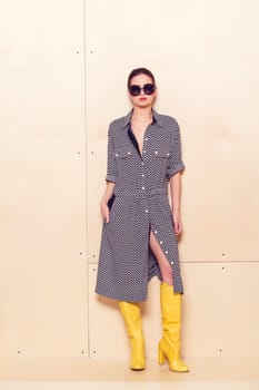 Full-length portrait of a lovely woman in romantic dress on wodden background