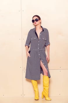 Full-length portrait of a lovely woman in romantic dress on wodden background