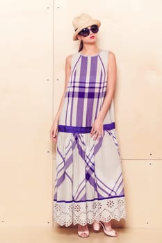 Full-length portrait of a lovely woman in romantic dress on wodden background