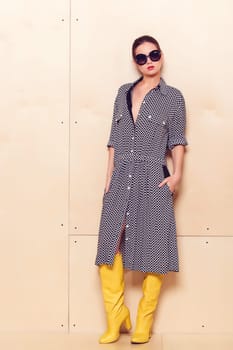 Full-length portrait of a lovely woman in romantic dress on wodden background