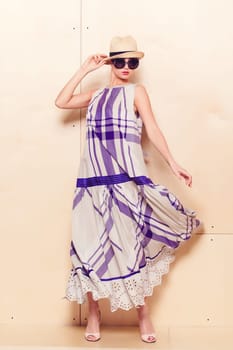 Full-length portrait of a lovely woman in romantic dress on wodden background