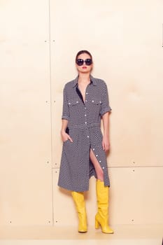 Full-length portrait of a lovely woman in romantic dress on wodden background