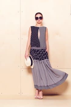 Full-length portrait of a lovely woman in romantic dress on wodden background