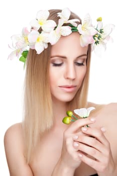Beautiful young blonde woman with a crown of flowers