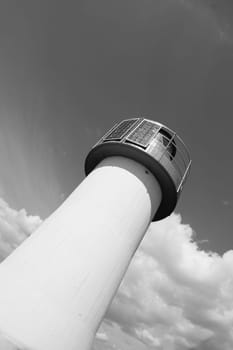 Lighthouse Photovoltaic Sky . Sea Mark at the harbor with blue sky with clouds in background