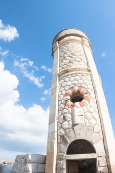 Lighthouse Photovoltaic Sky . Sea Mark at the harbor with blue sky with clouds in background