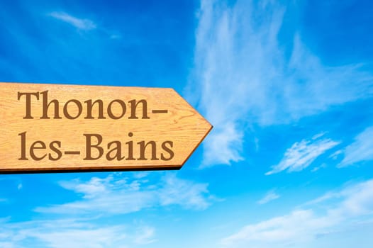 Wooden arrow sign pointing destination Versailles, FRANCE against clear blue sky with copy space available. Travel destination conceptual image