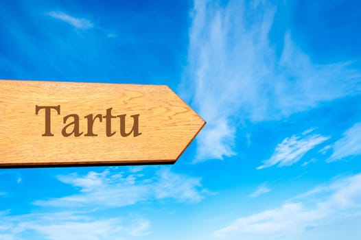 Wooden arrow sign pointing destination TALLINN, ESTONIA against clear blue sky with copy space available. Travel destination conceptual image