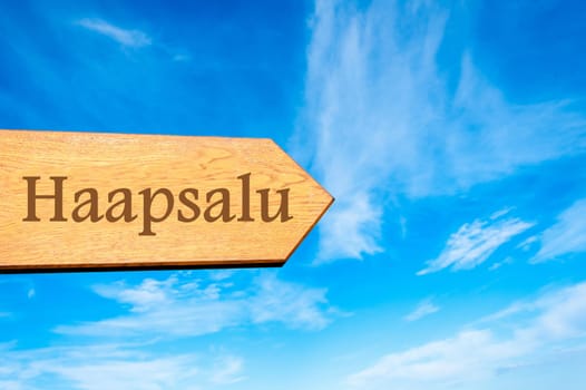 Wooden arrow sign pointing destination TALLINN, ESTONIA against clear blue sky with copy space available. Travel destination conceptual image