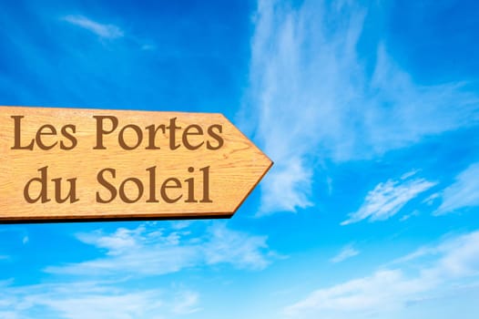 Wooden arrow sign pointing destination Versailles, FRANCE against clear blue sky with copy space available. Travel destination conceptual image