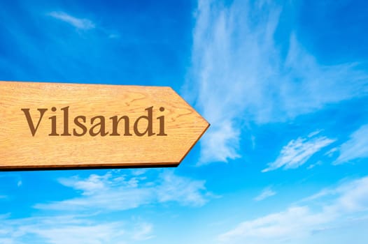 Wooden arrow sign pointing destination TALLINN, ESTONIA against clear blue sky with copy space available. Travel destination conceptual image