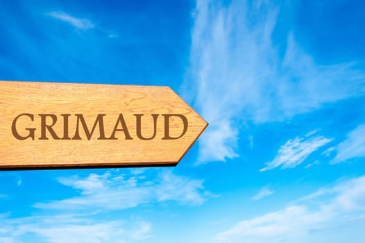 Wooden arrow sign pointing destination Versailles, FRANCE against clear blue sky with copy space available. Travel destination conceptual image