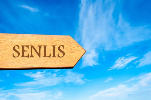 Wooden arrow sign pointing destination Versailles, FRANCE against clear blue sky with copy space available. Travel destination conceptual image