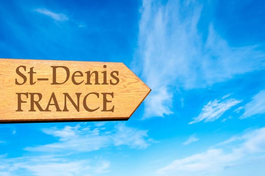 Wooden arrow sign pointing destination Versailles, FRANCE against clear blue sky with copy space available. Travel destination conceptual image