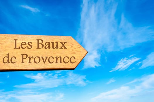Wooden arrow sign pointing destination Versailles, FRANCE against clear blue sky with copy space available. Travel destination conceptual image