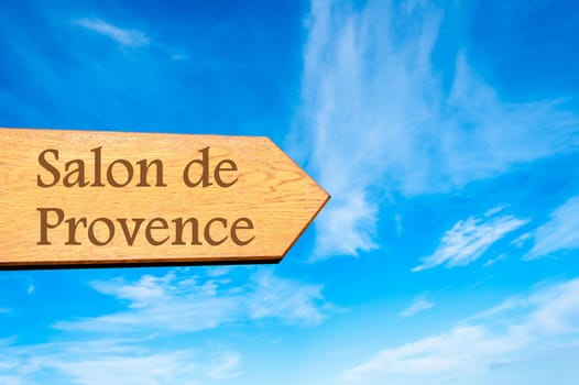 Wooden arrow sign pointing destination Versailles, FRANCE against clear blue sky with copy space available. Travel destination conceptual image