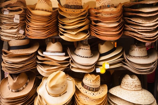A local vendor sells hats at a tourist venue