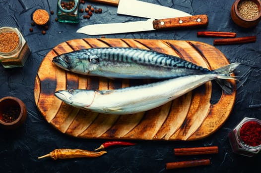 Raw mackerel fish and spices on the kitchen table. Seafood