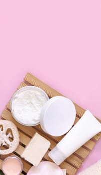 Handmade Cosmetic bottles and jars on pink flat lay, copy space. Brand package mockup. Natural beauty products, Top view