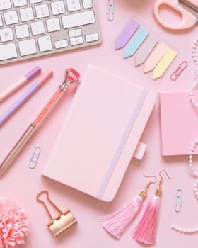 Hardcover notebook, Pink school accessories and keyboard on light pink, Top view, textbook mockup. Girly workplace with notebook, scissors, pencil, pen, paperclips, cards and watch. Back to school