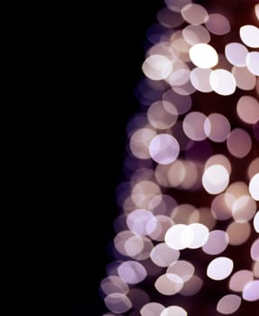 Christmas tree blur lights. Abstract bokeh background design with black copyspace