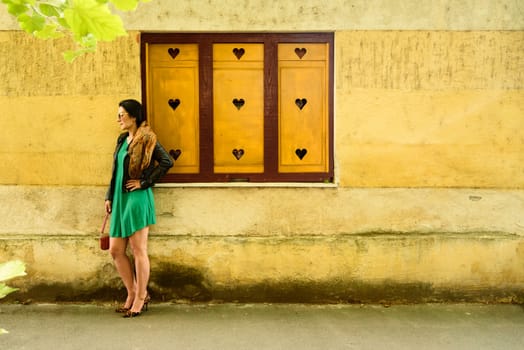 Beautiful modern young woman in fashion clothes on the street.