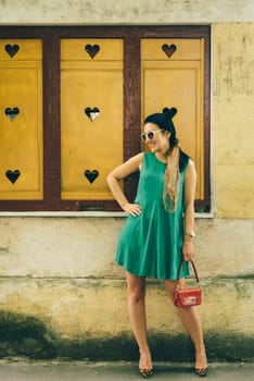 Beautiful modern young woman in fashion clothes on the street.