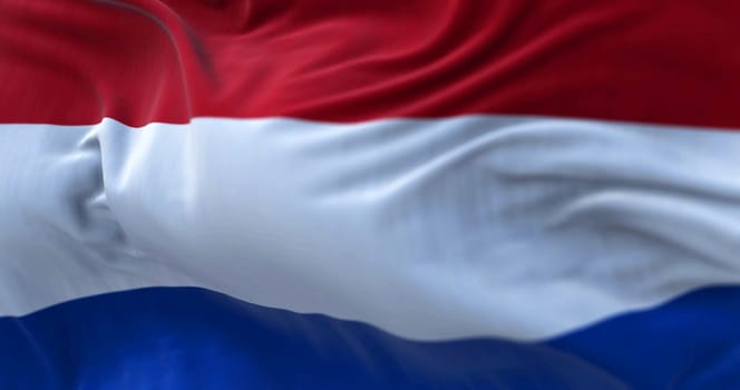 Close-up view of the Netherlands national flag waving in the wind. The Netherlands is a country located in Northwestern Europe. Fabric texture background. Selective focus