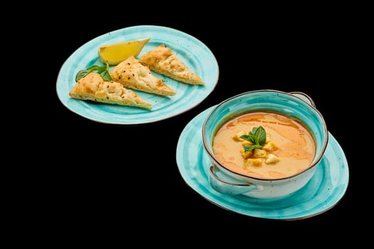 Classic lentil puree soup, Magic chorba on a black isolated background. High quality photo