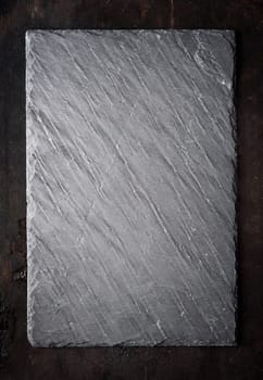 Black textured sushi slate board background with copyspace.
