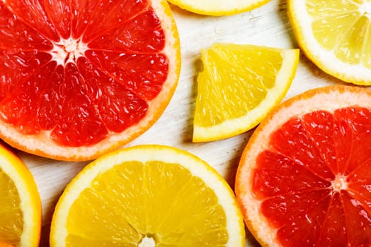 Citrus slices pattern background on whte wooden table.