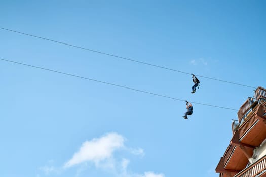 Two adventurous brave men on a zipline in Magdeburg in Germany
