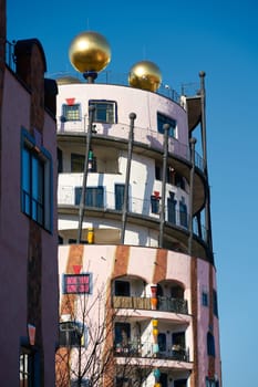 Detail of the Hundertwasserhaus in Magdeburg, the last project of the architect Hundertwasser, taken from a public street in the city center