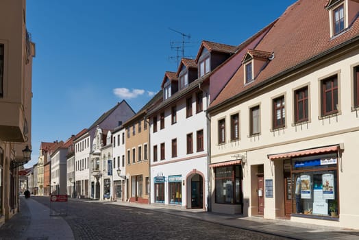 Street with some stores in the old town of Lutherstadt Wittenberg in Saxony-Anhalt in Germany