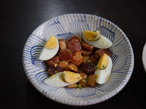 Spicy Chinese pork sausage with boiled egg Thai salad