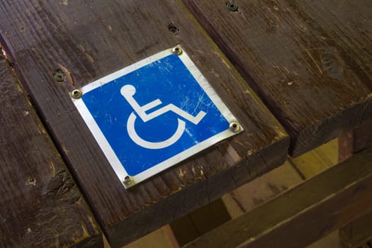 handicap wheelchair pictogram people accessibility symbol care access metal sign on wood