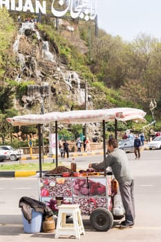 Lahijan, IRAN - July 31, 2019  Cart-driver selling beetroot and vicia faba in fornt of Shaytan hill -Lahijan city - Gilan Province