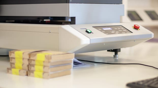Printing machines in production for printing on packages. Work on a flatbed, large format inkjet UV printer. Large format printing press in operation. Industry