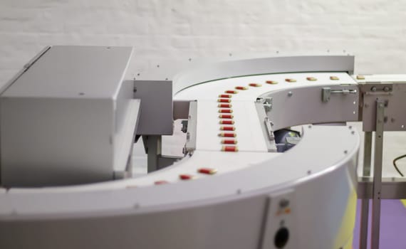Factory for the production of sweets and chocolate. Automatic line for the production of chocolate in an industrial factory. Conveyor belt with sweets. Sweets production process. Food industry