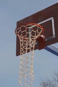 Basketball hoop with long braided net street basketball, low angle of view