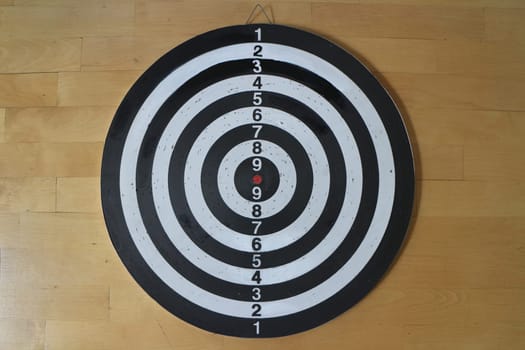 striped black and white Dartboard with numbering wooden background